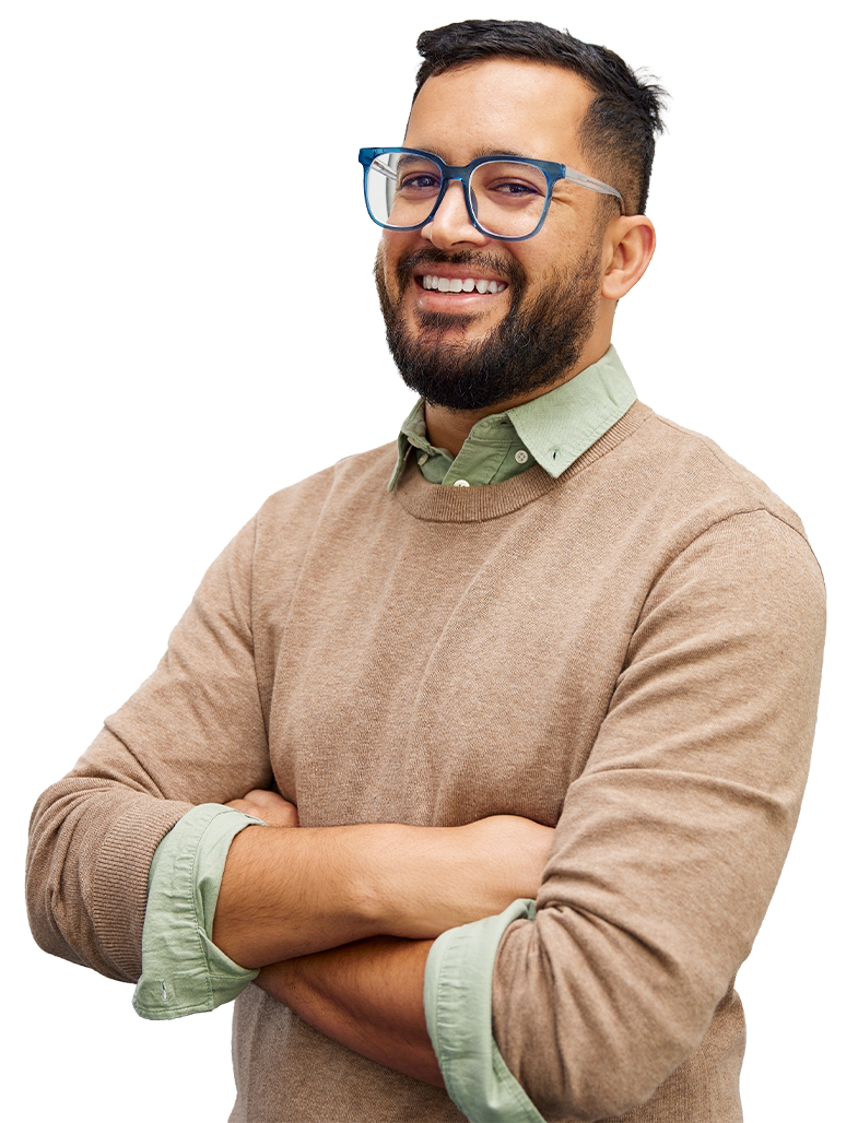 A professional wearing glasses, a green shirt and a brown jumper over the top