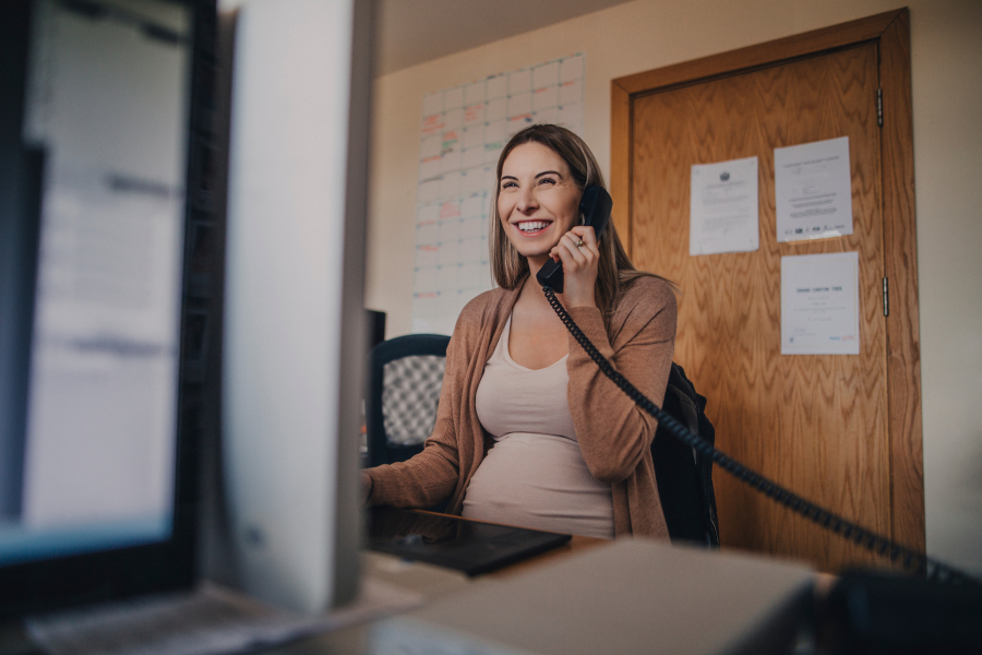 A professional smiling as they speak on the phone