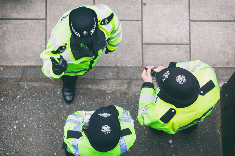 Three Community Support Police Officers stood talking