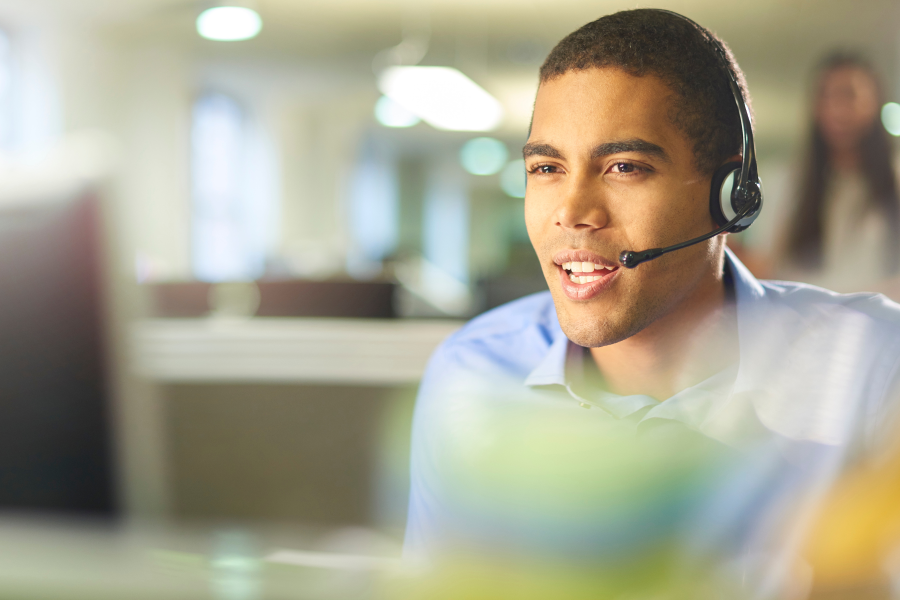 A smart professional sat speaking into a microphoned headset
