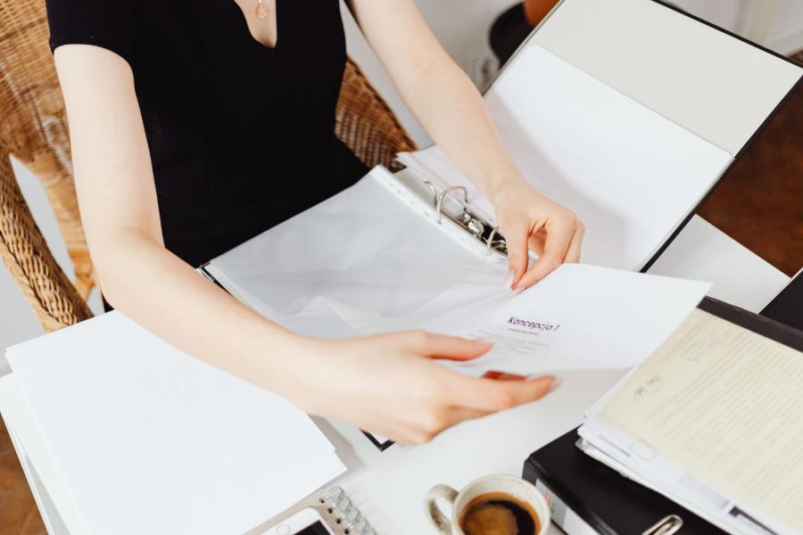 An adult holding documents