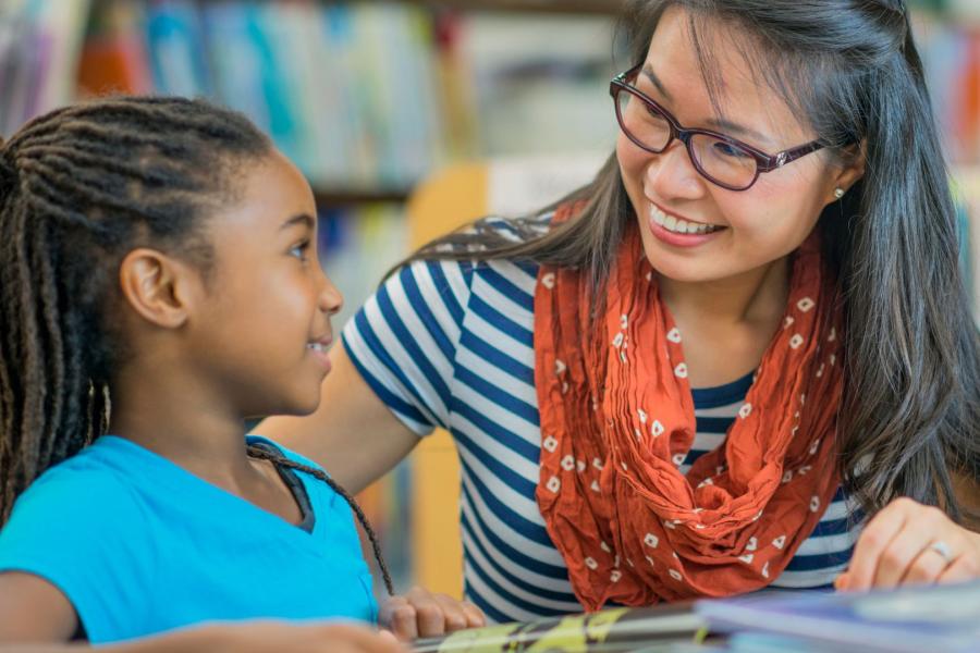 Tutor looking at a young child