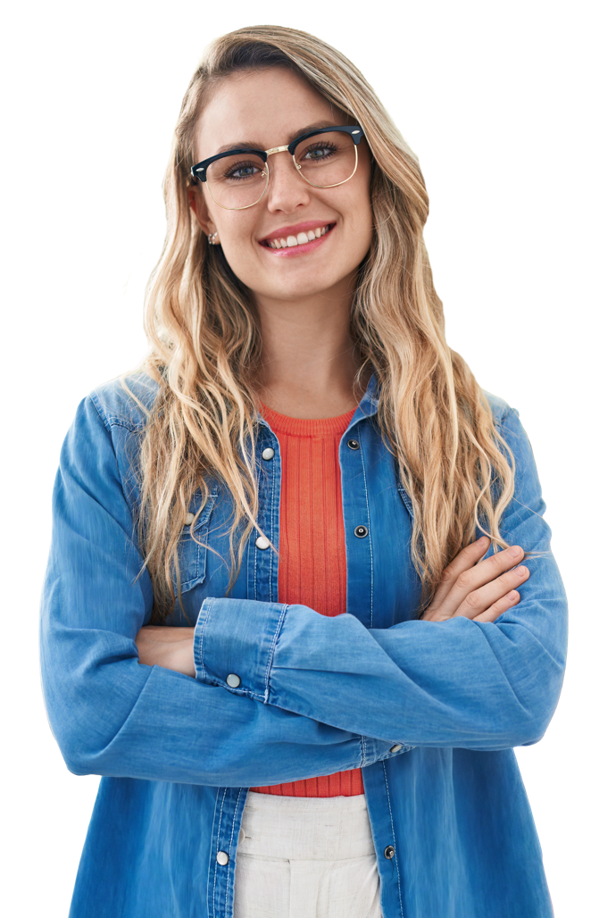 A person in a blue shirt and glasses is smiling whilst stood with their arms folded