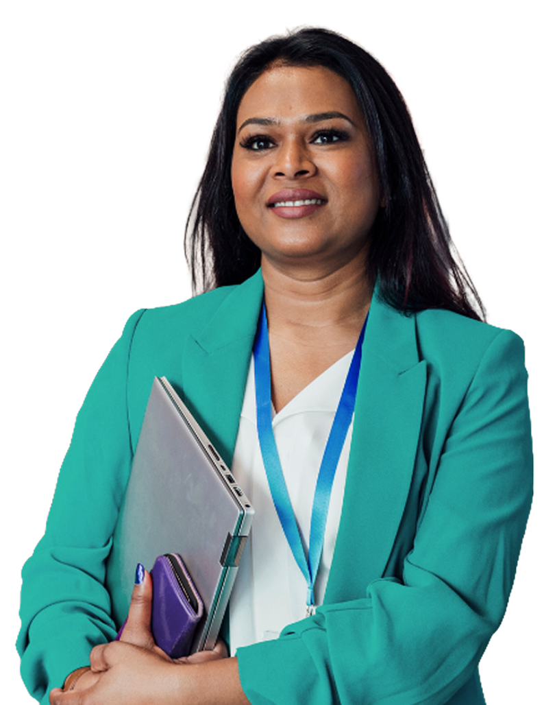 A person in a green blazer is smiling and holding a laptop