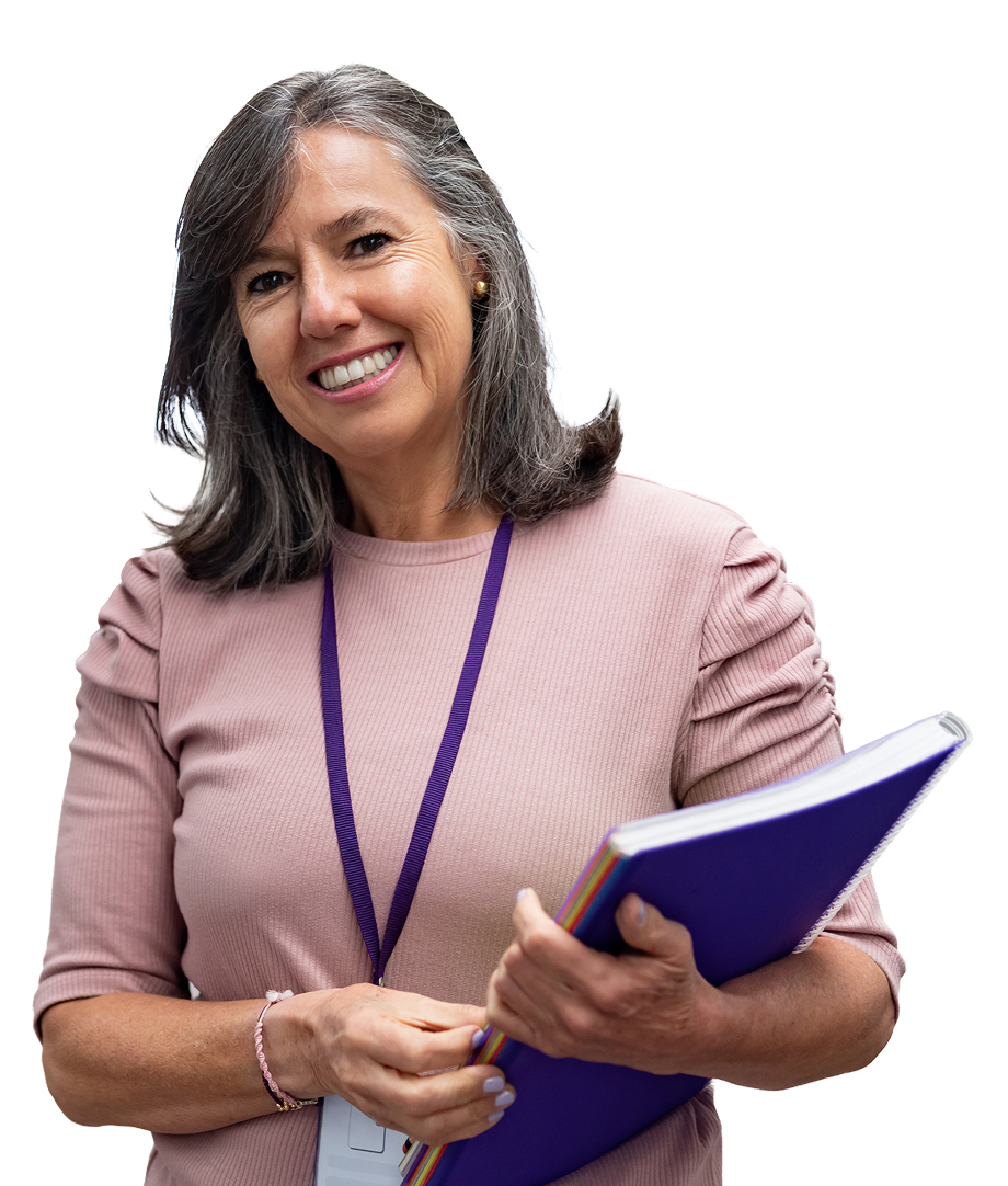 A person wearing a pink top is smiling and holding a notebook