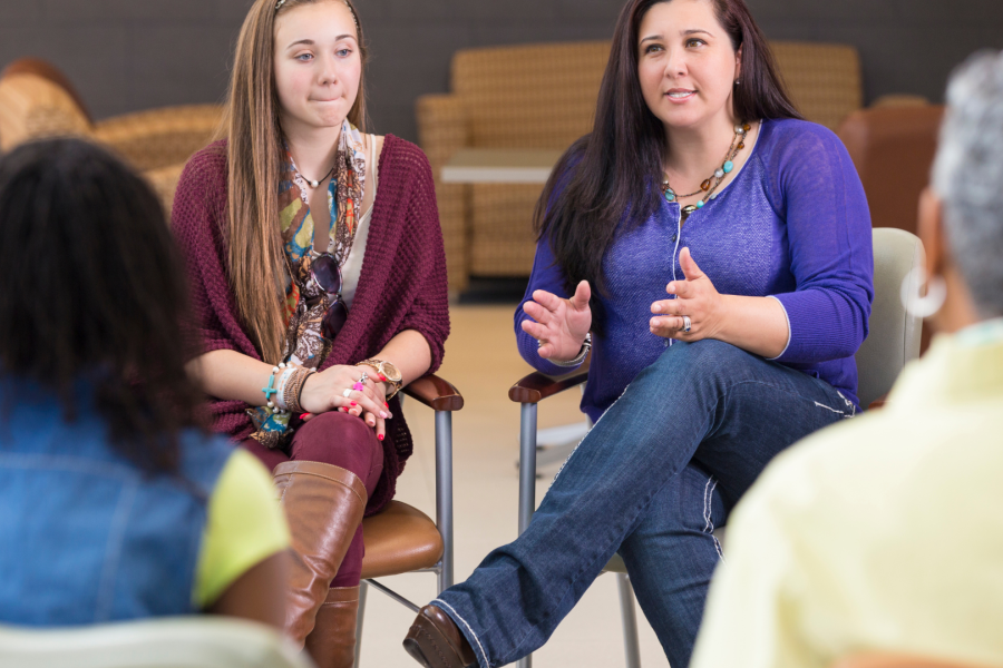 Two teachers having a discussion with a parent and a student
