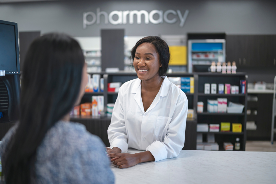 A Pharmacist smiling at a customer
