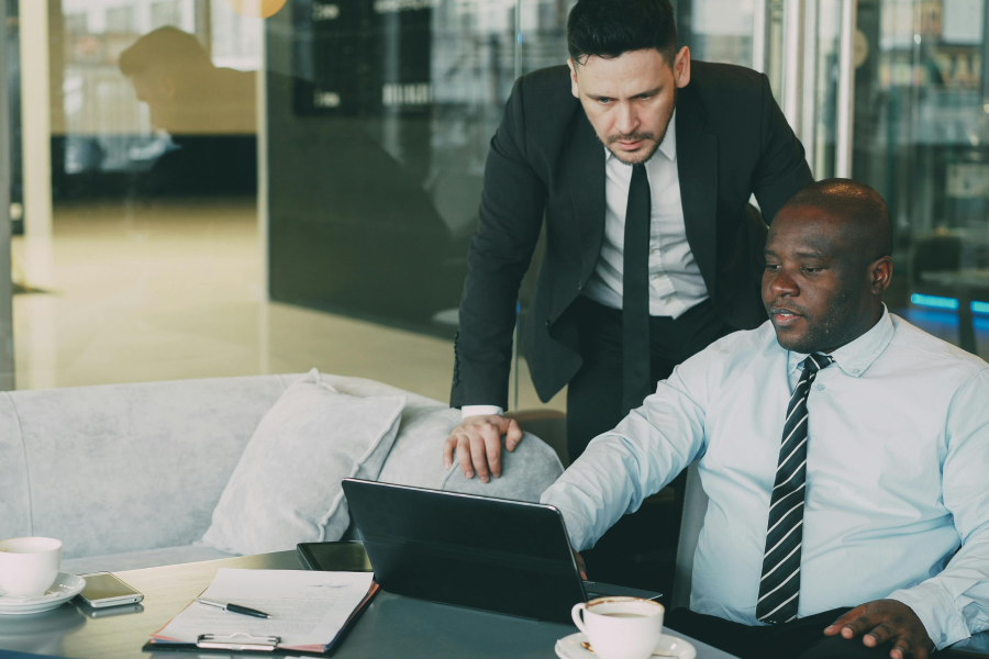 Two smart professionals looking at a laptop screen
