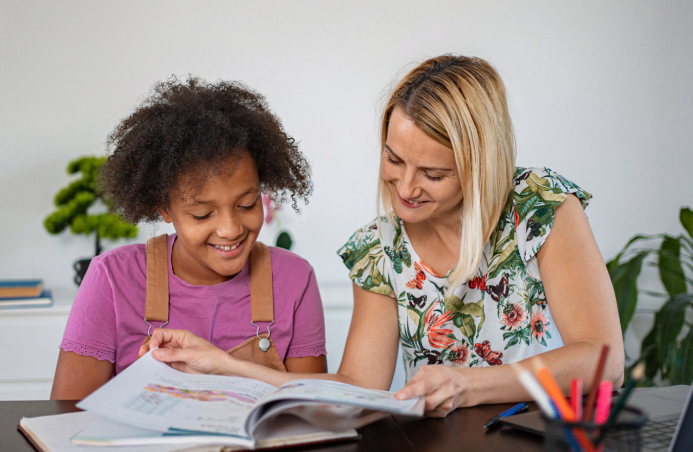 A professional reading a book with a young person