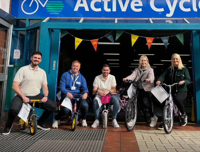 Spencer Clarke Group employees sat on bikes