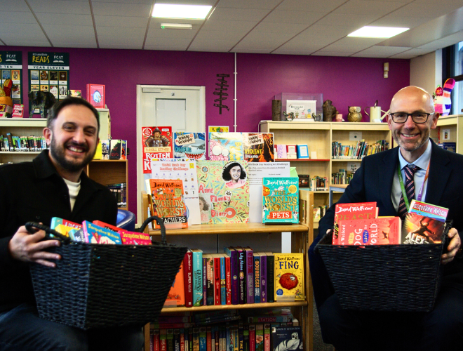 Spencer Clarke Group employee with a Headteacher in a school library