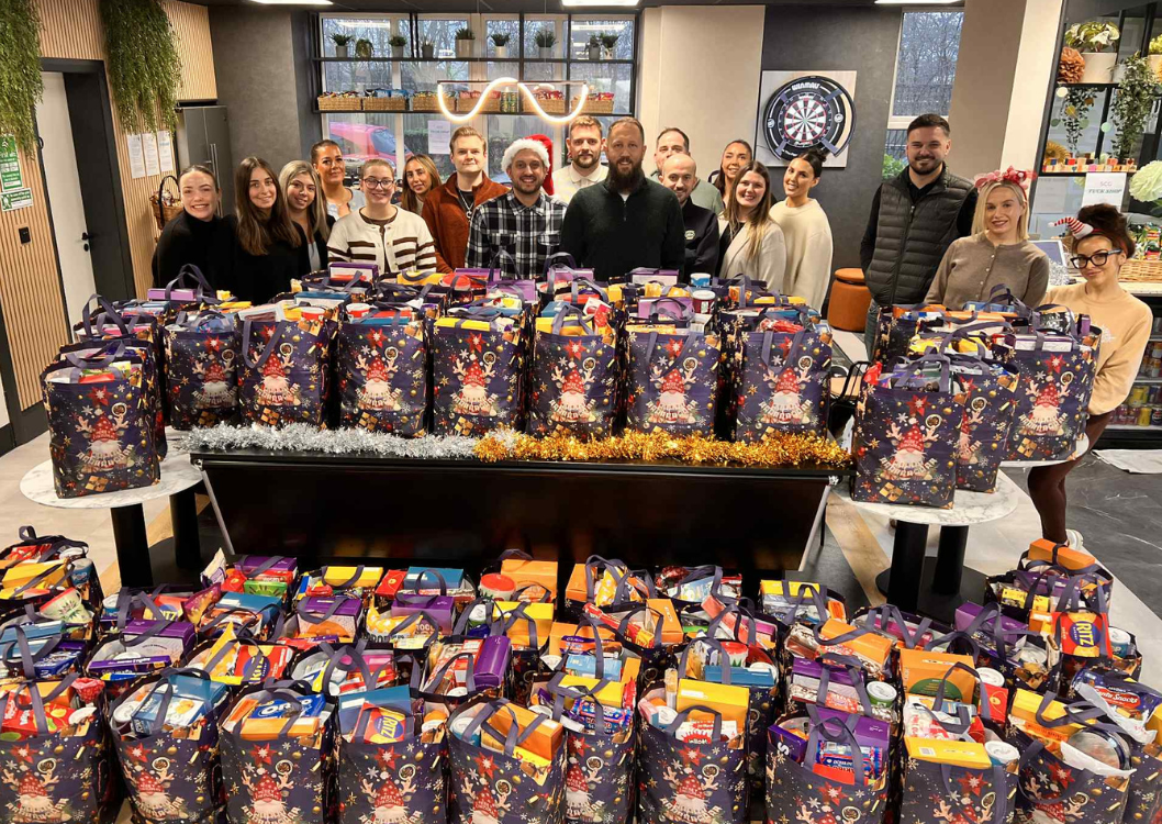 Spencer Clarke Group employees stood by Christmas food parcels
