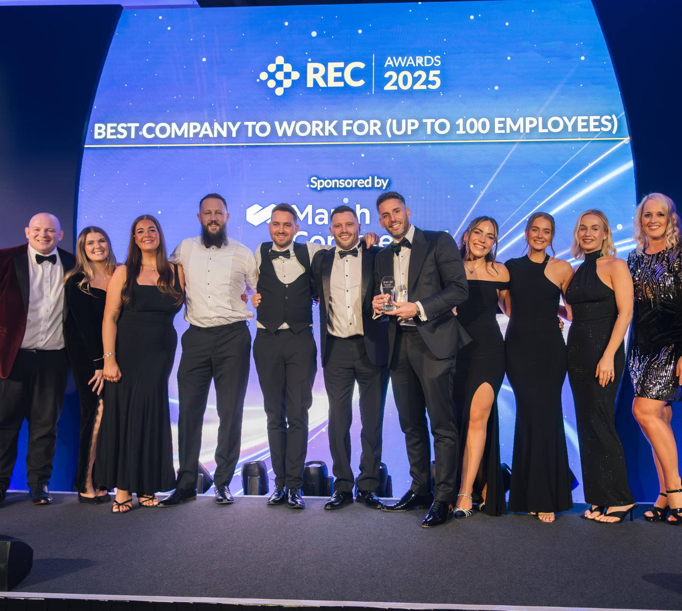 Spencer Clarke Group employees on stage at the 2025 REC Awards