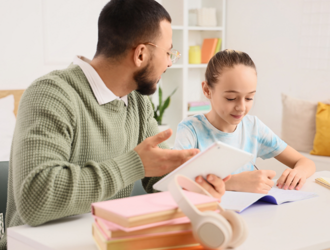 An adult holding a smart tablet, speaking to a young child