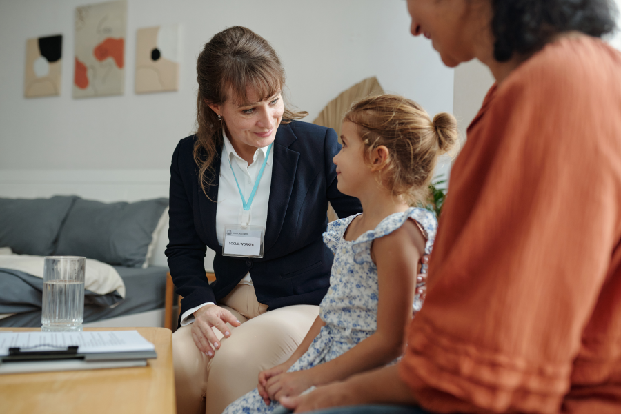 A young child sat between two adults