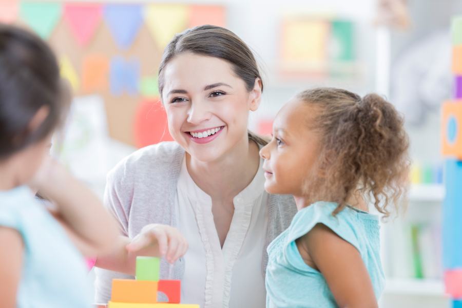 An adult smiling at a young child