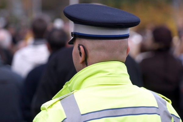 A Community Support Officer looking at a crowd